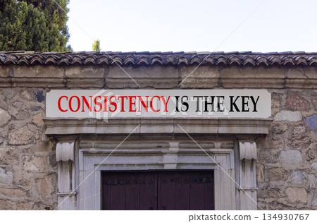 Consistency is the key symbol. Concept words Consistency is the key on beautiful white marble sign plate. Beautiful stone wall background. Business consistency is the key concept. Copy space. 134930767