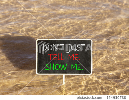 Tell or show symbol. Concept words Do not just tell me, show me on beautiful blackboard. Beautiful Red sea water background. Business tell or show concept. Copy space. Tell or show symbol. Concept words Do not just tell me, show me on beautiful blackboard. Beautiful Red sea water background. Business tell or show concept. Copy space. 134930788