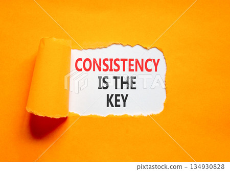 Consistency is the key symbol. Concept words Consistency is the key on beautiful white paper. Beautiful orange paper background. Business consistency is the key concept. Copy space. Consistency is the key symbol. Concept words Consistency is the key on beautiful white paper. Beautiful orange paper background. Business consistency is the key concept. Copy space. 134930828