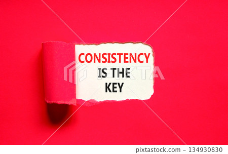 Consistency is the key symbol. Concept words Consistency is the key on beautiful white paper. Beautiful red paper background. Business consistency is the key concept. Copy space. 134930830