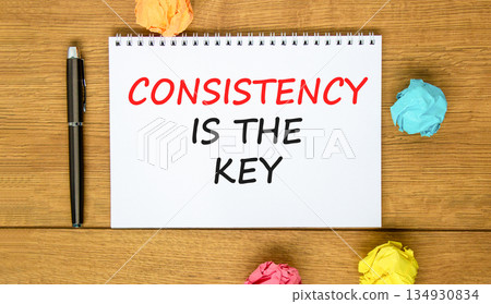 Consistency is the key symbol. Concept words Consistency is the key on beautiful white note. Beautiful wooden background. Black pen. Business consistency is the key concept. Copy space. 134930834