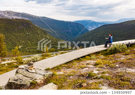 Woman on Vedahaugane rest stop, Norway Woman on Vedahaugane rest stop, Norway 134930997