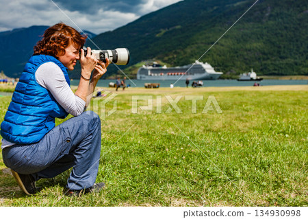 Woman take travel photo in Flam Norway Woman take travel photo in Flam Norway 134930998