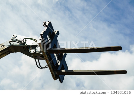 Forklift industrial loader or stacker against sky. Forklift industrial loader or stacker against sky. 134931036
