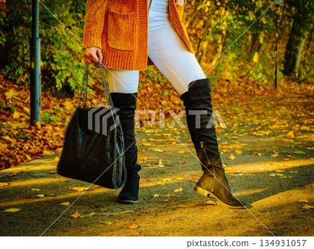 Woman wearing orange autumn cardigan outdoor 134931057