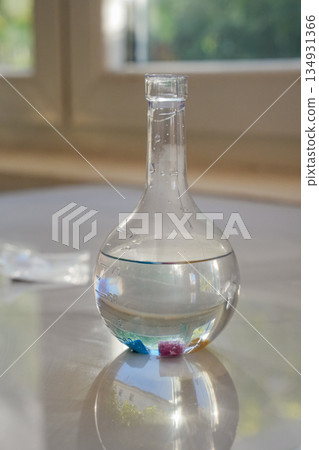 Glass Flask with Liquid and Crystals Vertical 134931366