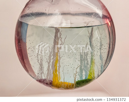 Glass Flask with Fully Grown Crystals on Table Medium Shot 134931372