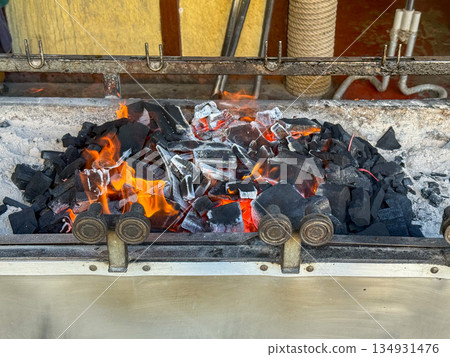 Burning Charcoal in Grill Firebox Burning Charcoal in Grill Firebox 134931476