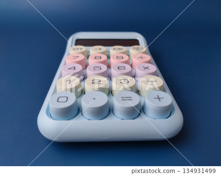 Top view pastel-colored desktop calculator featuring a retro typewriter style with large, round mechanical keys. Top view pastel-colored desktop calculator featuring a retro typewriter style with large, round mechanical keys. 134931499