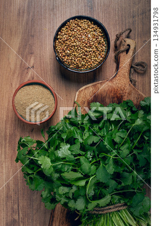 a bunch of fresh cilantro, coriander seeds and powder bowls, close-up, top view, no people, food and drinks, 134931798