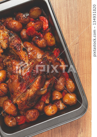Pork knuckle, baked with vegetables, new potatoes , on a baking sheet, homemade, no people, Pork knuckle, baked with vegetables, new potatoes , on a baking sheet, homemade, no people, 134931820