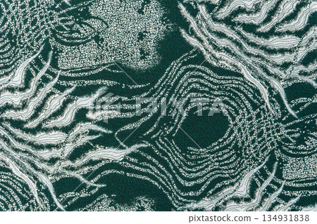 Dark teal jacquard fabric texture with metallic lurex and abstract wave pattern, part of textile collection Dark teal jacquard fabric texture with metallic lurex and abstract wave pattern, part of textile collection 134931838