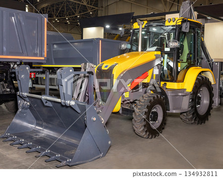 Modern construction machinery showcased at the industry trade fair in vibrant exhibition hall Modern construction machinery showcased at the industry trade fair in vibrant exhibition hall 134932811
