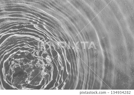 drops on water with circles on a grey background drops on water with circles on a grey background 134934282