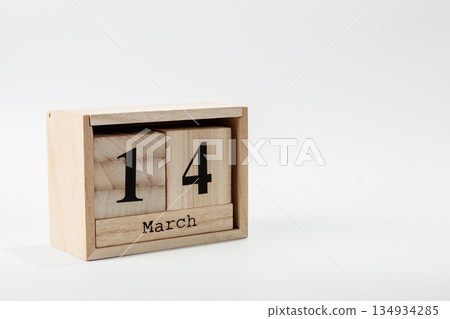 Wooden calendar March 14 on a white background Wooden calendar March 14 on a white background 134934285