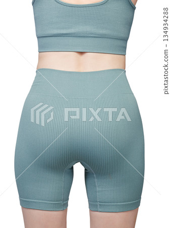 Sports jacket of green color, women's sports suit seamless, jacket for yoga training on a girl on an isolated white background 134934288