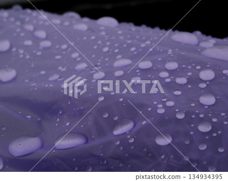 Drops of water on the blue plastic film detailed Drops of water on the blue plastic film detailed 134934395