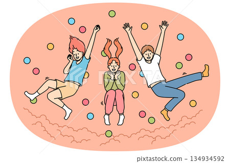 Children jump in pool with balls, laughing and enjoying opportunity to frolic with friends 134934592