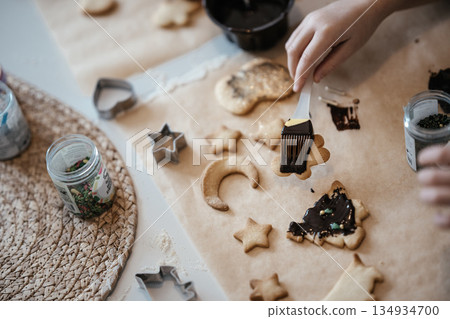 Homemade Christmas Cookies In Preparation: Hands Kneading Dough, Cutting Shapes, And Decorating Biscuits With Chocolate In Cozy Kitchen Atmosphere Homemade Christmas Cookies In Preparation: Hands Kneading Dough, Cutting Shapes, And Decorating Biscuits With Chocolate In Cozy Kitchen Atmosphere 134934700