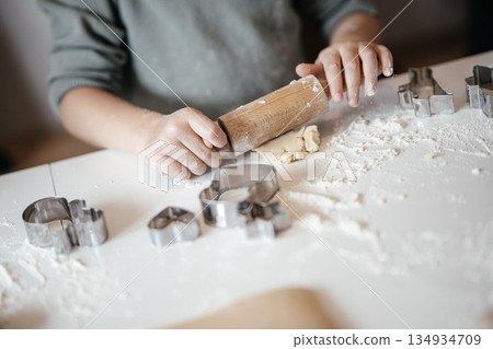 Homemade Christmas Cookies In Preparation: Hands Kneading Dough, Cutting Shapes, And Decorating Biscuits With Chocolate In Cozy Kitchen Atmosphere 134934709