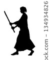A man in a karate uniform holding a wooden sword (silhouette, black) 134934826