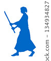 A man in a karate uniform holding a wooden sword (silhouette, blue) 134934827
