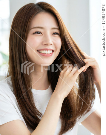 Smiling young woman touching her beautiful long hair. Hair care beauty material 134934878