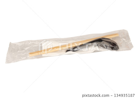 Spoons chopsticks and tissues are in a clear plastic bag These are eating utensils isolated on white background Spoons chopsticks and tissues are in a clear plastic bag These are eating utensils isolated on white background 134935187