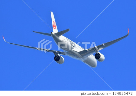 JAL plane flying in the blue sky JAL plane flying in the blue sky 134935472