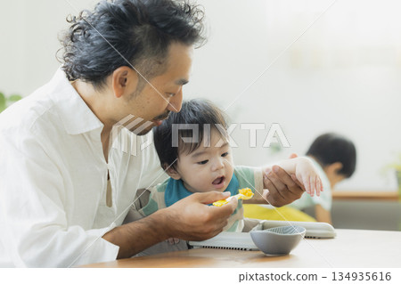 Baby eating baby food Baby eating baby food 134935616