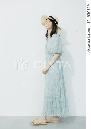 A young woman wearing a light blue dress 134936119