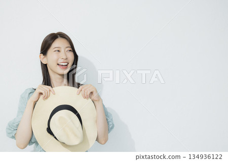 A young woman wearing a light blue dress 134936122