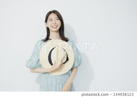 A young woman wearing a light blue dress 134936123