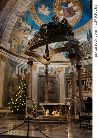 Basilica of the Holy Cross in Jerusalem Rome apse with mosaic baldachin and nativity scene Christmas decorations ornate Catholic church interior editorial use only. High quality photo 134936163