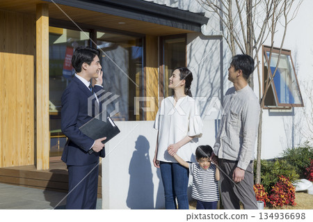 A salesman showing around a housing exhibition 134936698