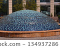 Mosaic-tiled dome structure in a public plaza in Kuala Lumpur, Malaysia, showcasing modern urban design, texture, and architectural detail. 134937286