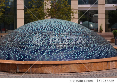 Mosaic-tiled dome structure in a public plaza in Kuala Lumpur, Malaysia, showcasing modern urban design, texture, and architectural detail. 134937286
