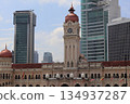 Historic Sultan Abdul Samad Building framed by modern skyscrapers in Kuala Lumpur, Malaysia, highlighting the contrast between heritage and contemporary city life. 134937287