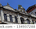 Weathered colonial-era building facade in Kuala Lumpur, Malaysia, showing aged textures, ornate details, and historic urban architecture. 134937288