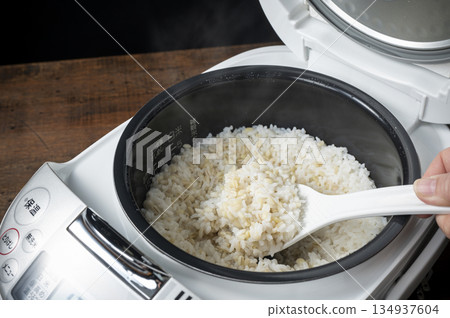 Freshly cooked sticky barley rice in a rice cooker 134937604
