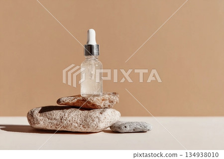 Glass dropper bottle with extract coconut or serum on stand from natural stones on beige background. Natural Organic Spa Cosmetic concept, cosmetic product mock up, minimal style. Side view, copyspace Glass dropper bottle with extract coconut or serum on stand from natural stones on beige background. Natural Organic Spa Cosmetic concept, cosmetic product mock up, minimal style. Side view, copyspace 134938010