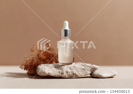 Glass dropper bottle with extract coconut or serum on stand from natural stones on beige background. Natural Organic Spa Cosmetic concept, cosmetic product mock up, minimal style. Side view, copyspace Glass dropper bottle with extract coconut or serum on stand from natural stones on beige background. Natural Organic Spa Cosmetic concept, cosmetic product mock up, minimal style. Side view, copyspace 134938013