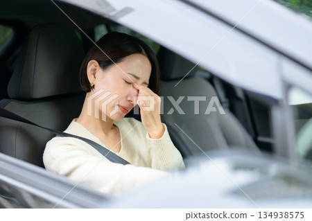 A woman who feels tired while driving A woman who feels tired while driving 134938575