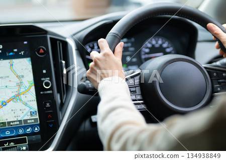 Woman driving car navigation system 134938849
