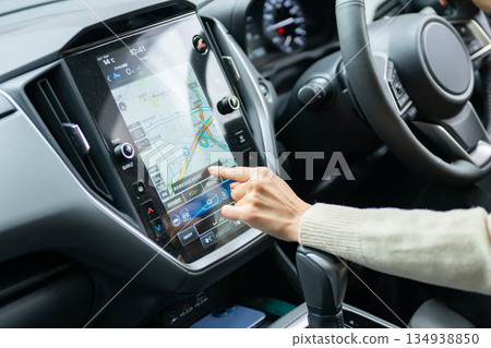Woman driving car navigation system 134938850