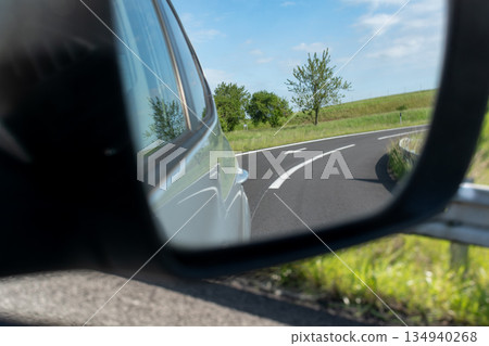 Car rearview mirror showing nature Car rearview mirror showing nature 134940268