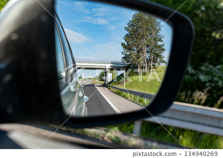 Car rearview mirror showing nature Car rearview mirror showing nature 134940269