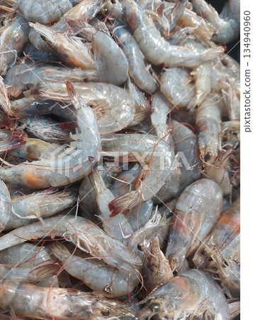 Shrimp. Fresh raw shrimps at the market for sell. Heap of prawns with top view. Shrimp pattern, prawn texture.  134940960