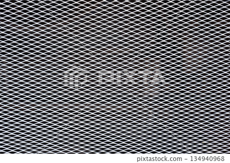White expanded metal mesh on black background. White expanded metal mesh on black background. 134940968