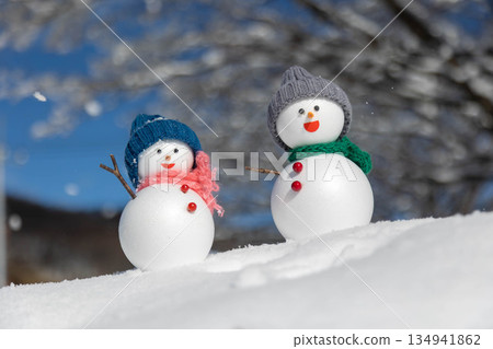 Fresh snow and a pair of snowmen 134941862